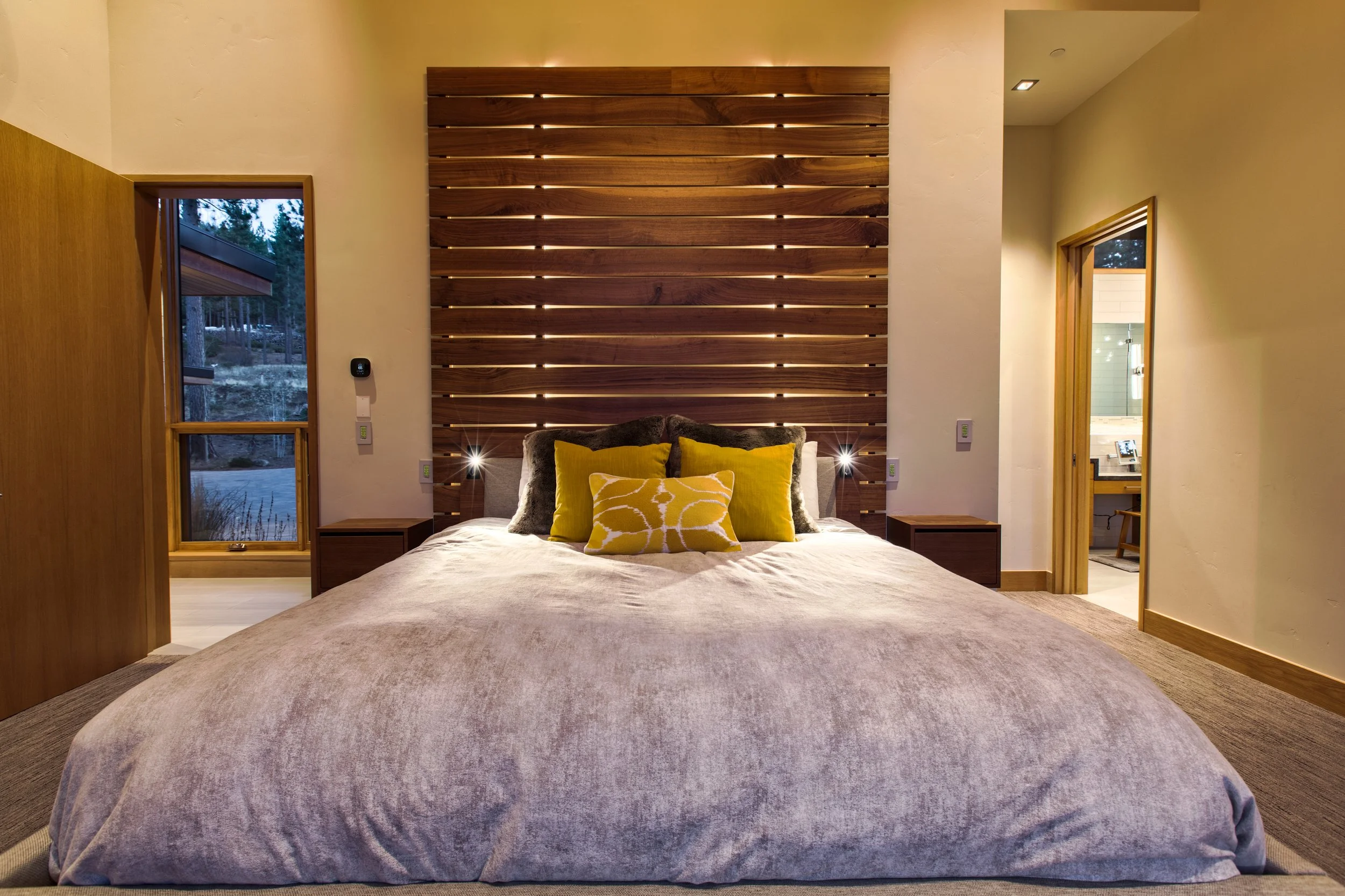 Custom walnut and upholstered king bed with floating nightstands and two headboards with custom reading lights and accent LED lighting