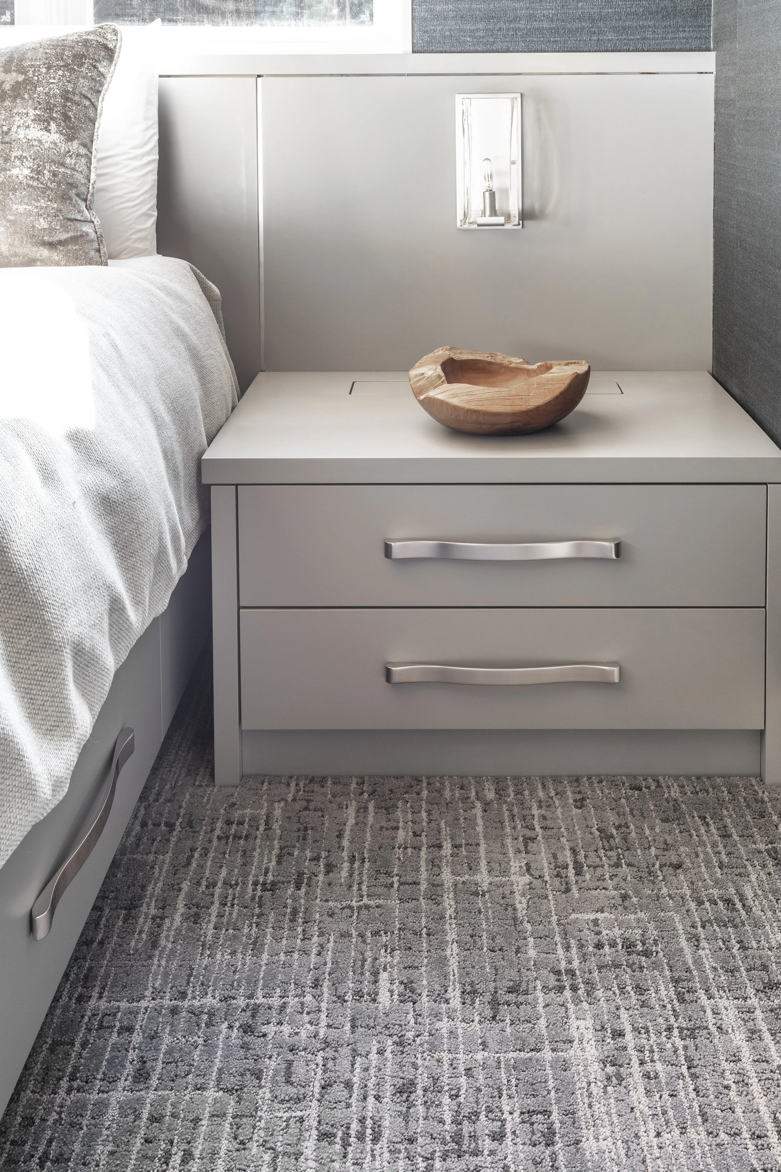 Custom designed and built-in bed, headboard, and nightstands that have hidden outlets for charging devices. Walls covered in wallpaper and the ceiling is clad in cedar T&G wood in Martis Camp in Truckee, CA.