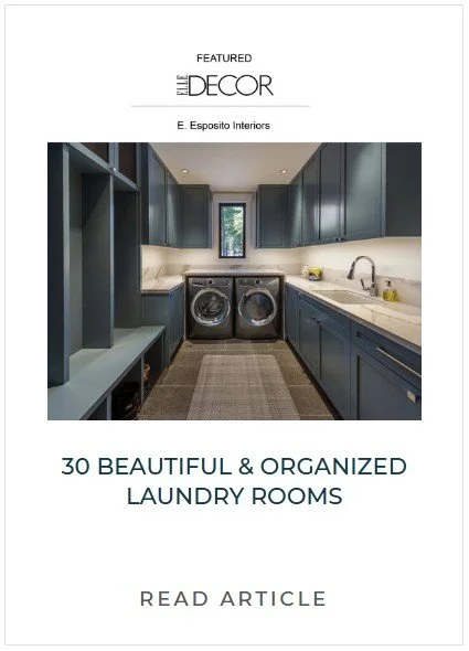 A laundry room with dark blue cabinets, a window, a countertop, a sink, and a washing machine and dryer in the center.