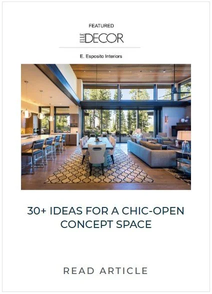 Interior of a spacious, modern open-concept living and dining area with large windows, contemporary furniture, and a patterned rug.