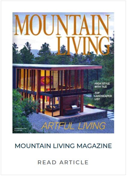 Cover of Mountain Living magazine featuring a modern elevated house with a wooden exterior, large windows, surrounded by trees and greenery.