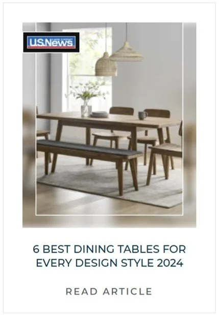 A minimalist dining room with a wooden dining table, matching chairs, a bench, a vase with flowers, and hanging pendant lights, with a U.S. News logo in the top left corner.