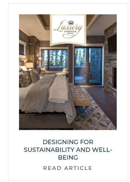 A cozy bedroom with stone accents, large windows opening to a forest view, and a mix of modern and rustic decor.