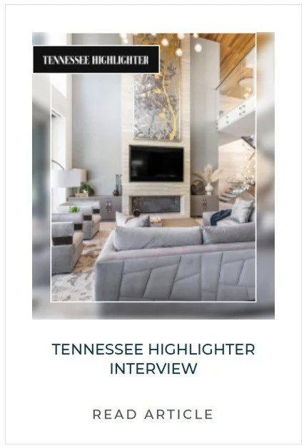 Modern living room with a large gray sofa, a fireplace, mounted flat-screen TV, and contemporary artwork on the wall.