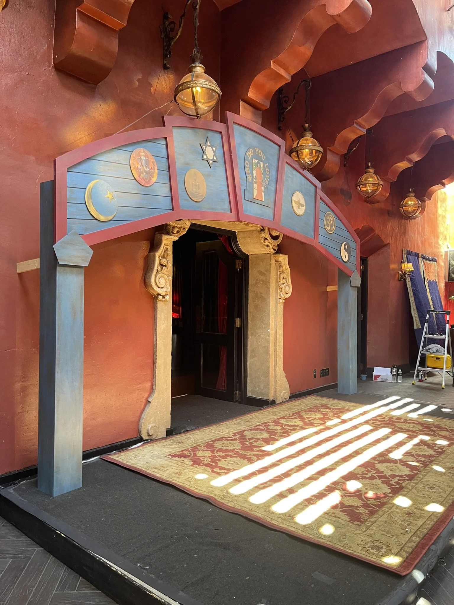 House of Blues reunion replica signage. Decorative set design with a colorful archway featuring zodiac symbols. 