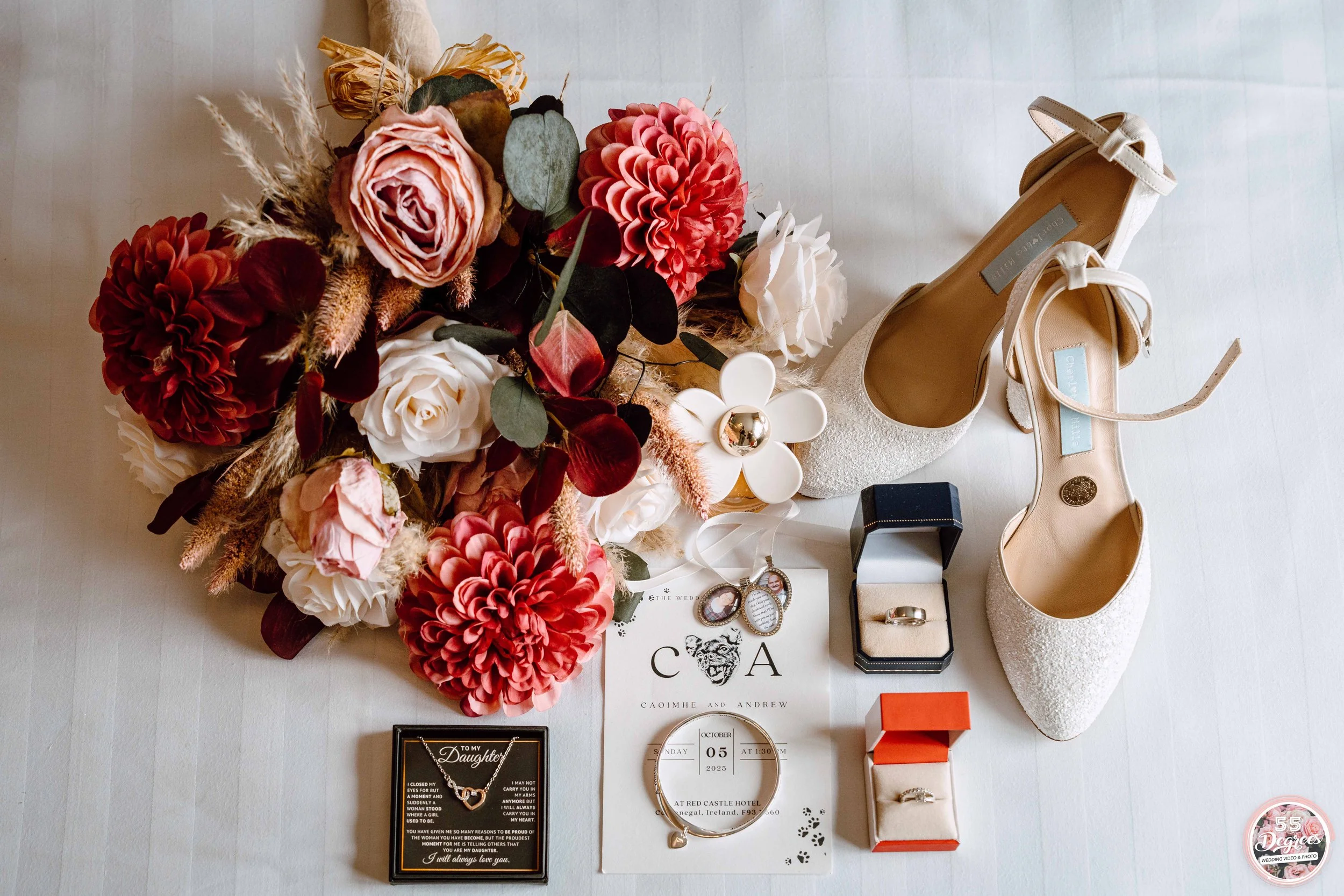 Wedding accessories and decor including a bouquet of pink, red, and white flowers, a pair of white high-heeled shoes, a jewelry box with rings, earrings, a bracelet, and a wedding invitation with a date of October 5, 2025.