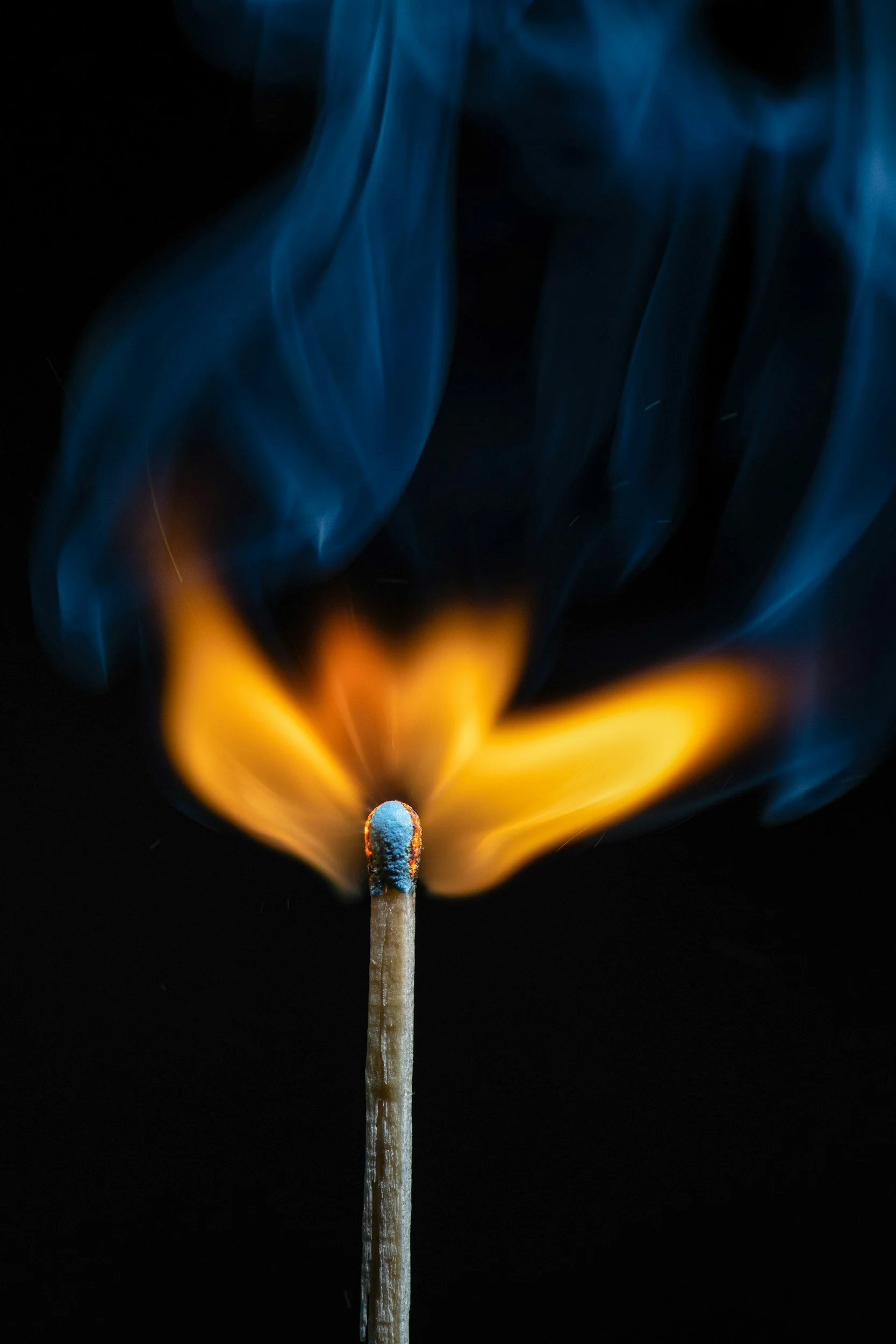 A lit match with orange flames
