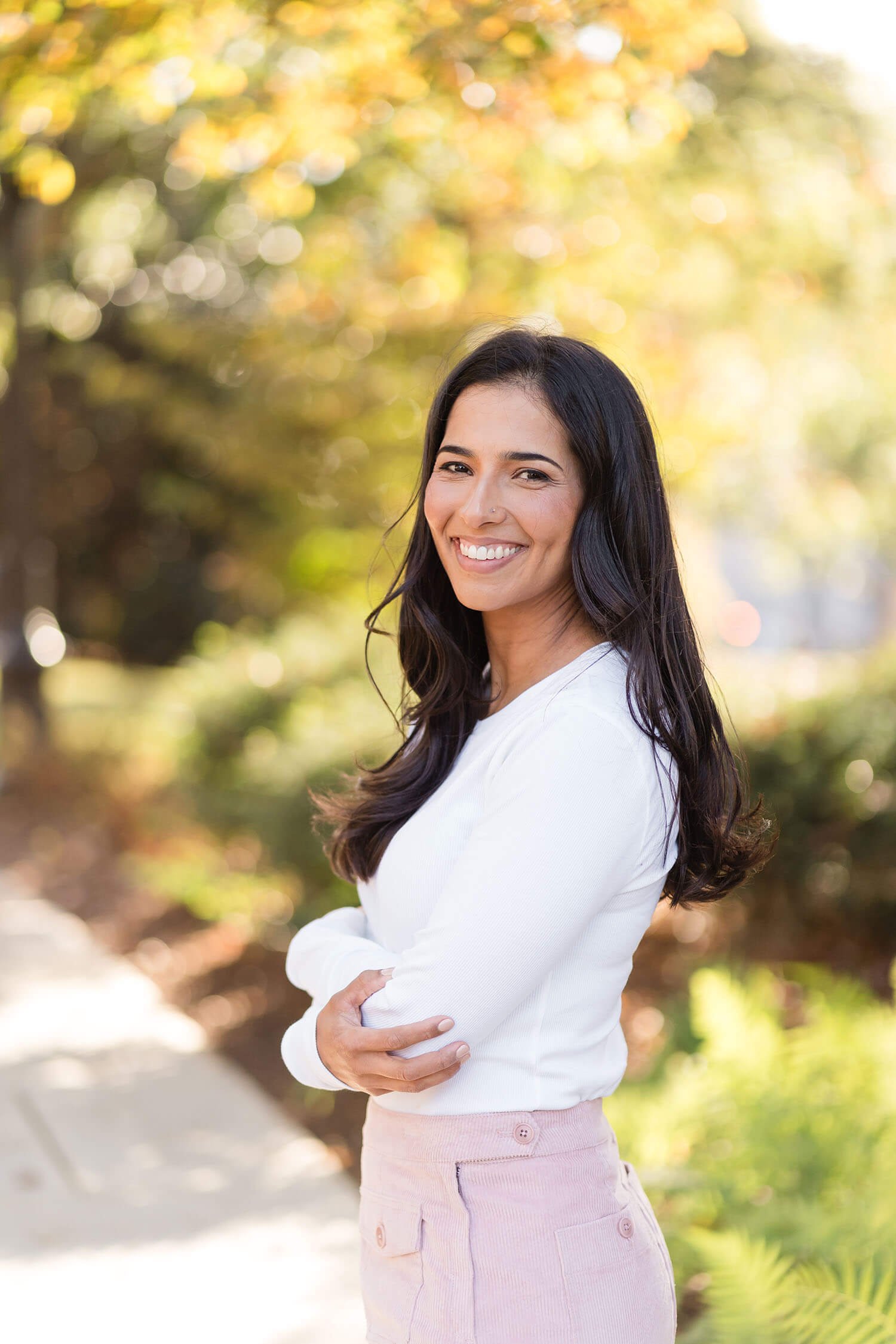 Lenet smiles over her left shoulder, standing outdoors
