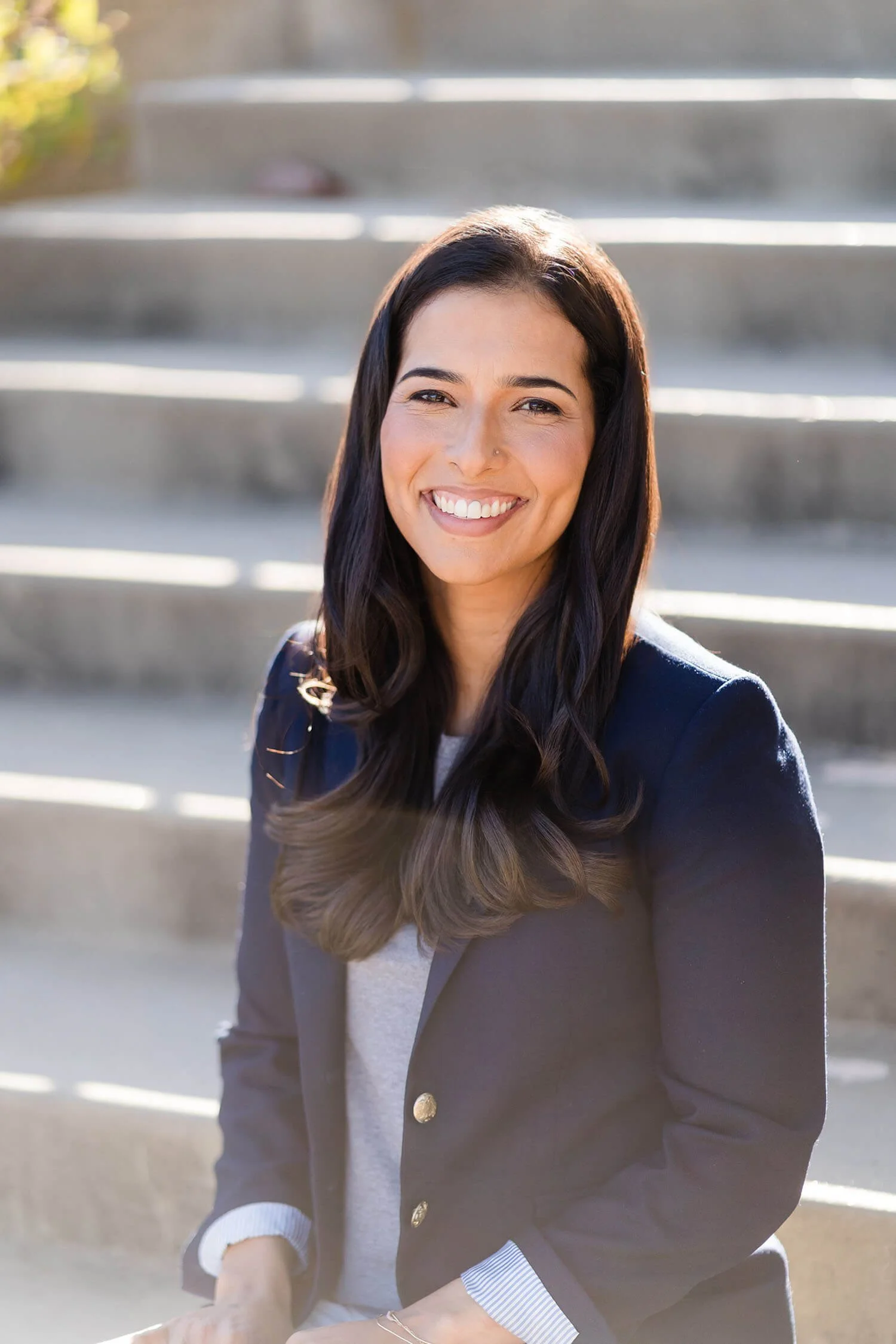 Lenet smiles in a navy blazer