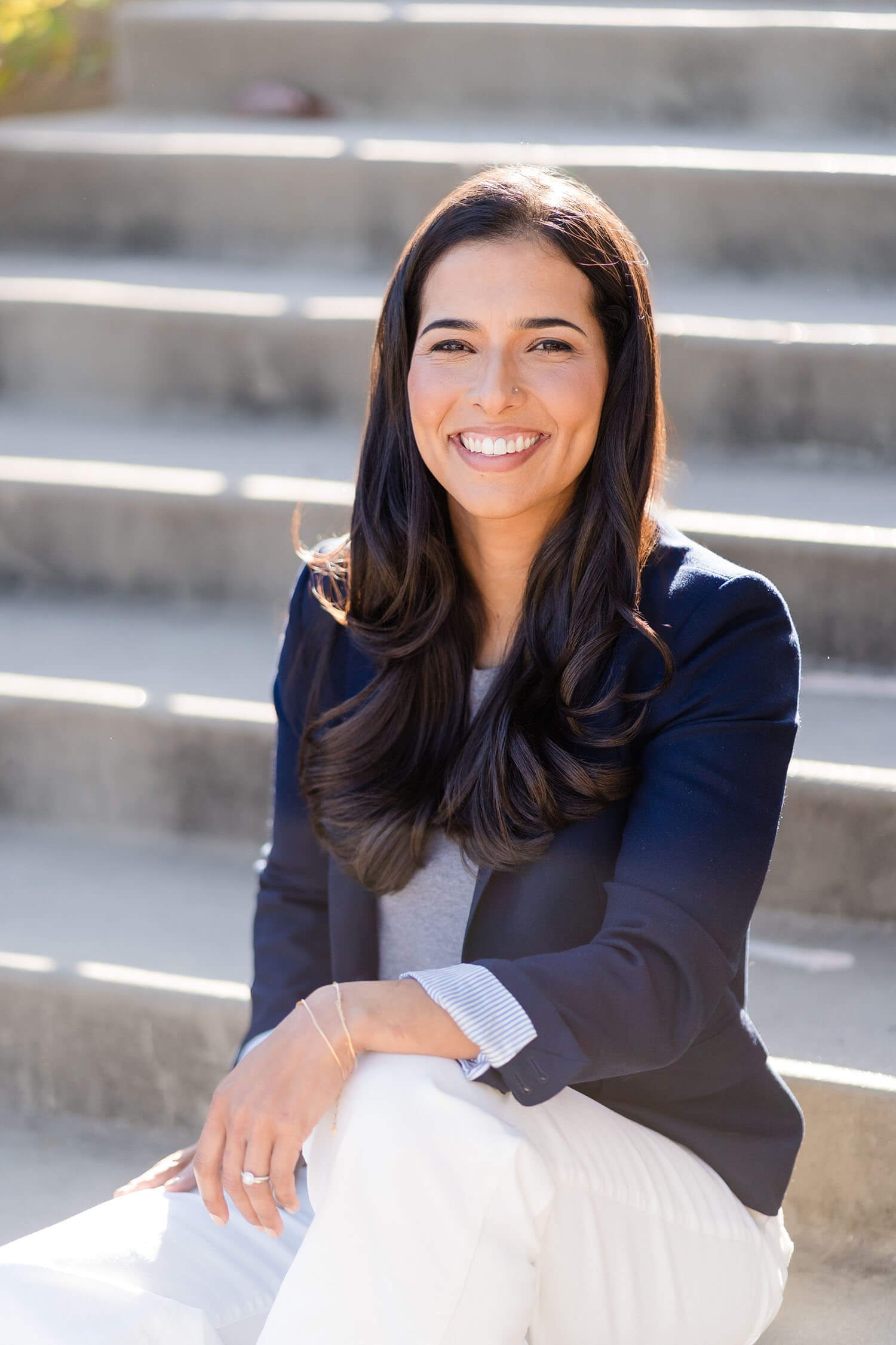 Lenet smiles in a navy blazer