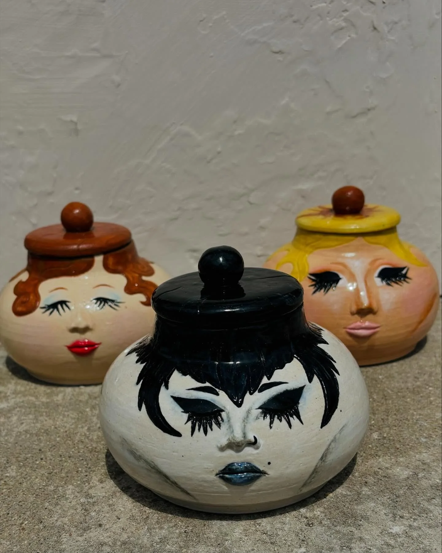 jars!!!!!! some thrown jars with different makeup styles i recreated in under glaze🫶 i made trad goth, 1920s, and drag makeup (inspo from @trixiemattel ) in some universe (mine) all of these jars are sisters💅 these were super fun but making lids is