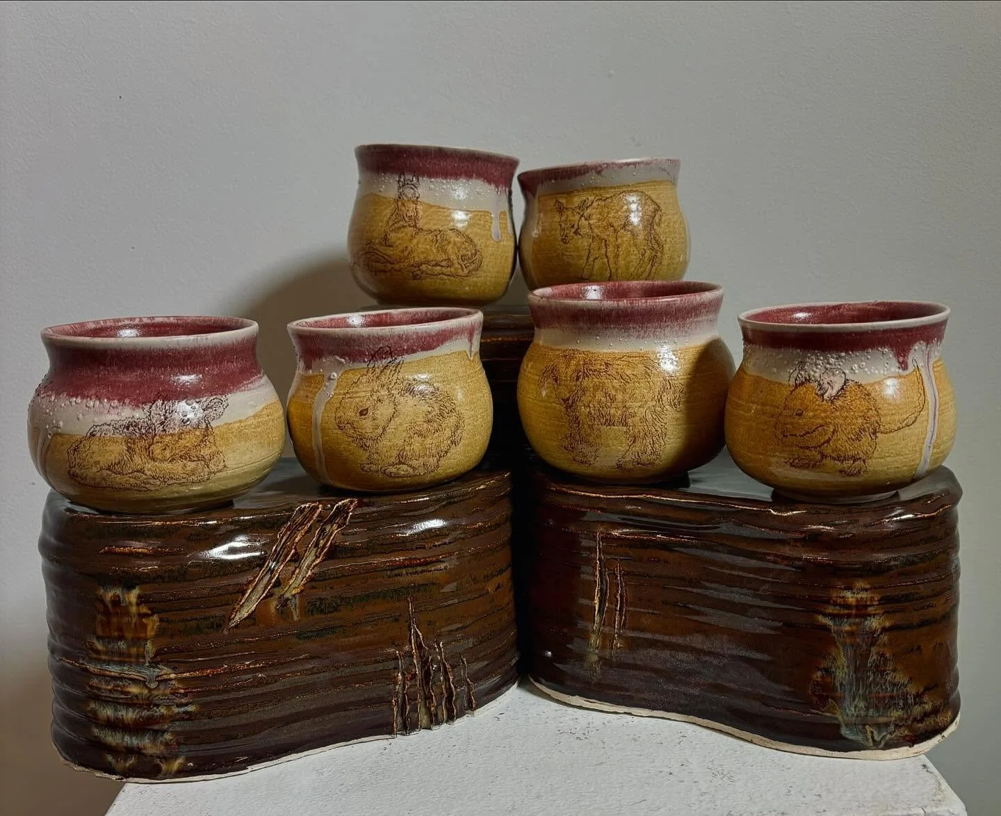 prey and predator ceramic cup set ⋆✴︎˚｡⋆ i digitally drew the baby prey animals and i used iron transfers to fire them onto my cups :D the pedestals have very abstracted predator animals on them (the glaze ran more than i thought lol) this was my fir