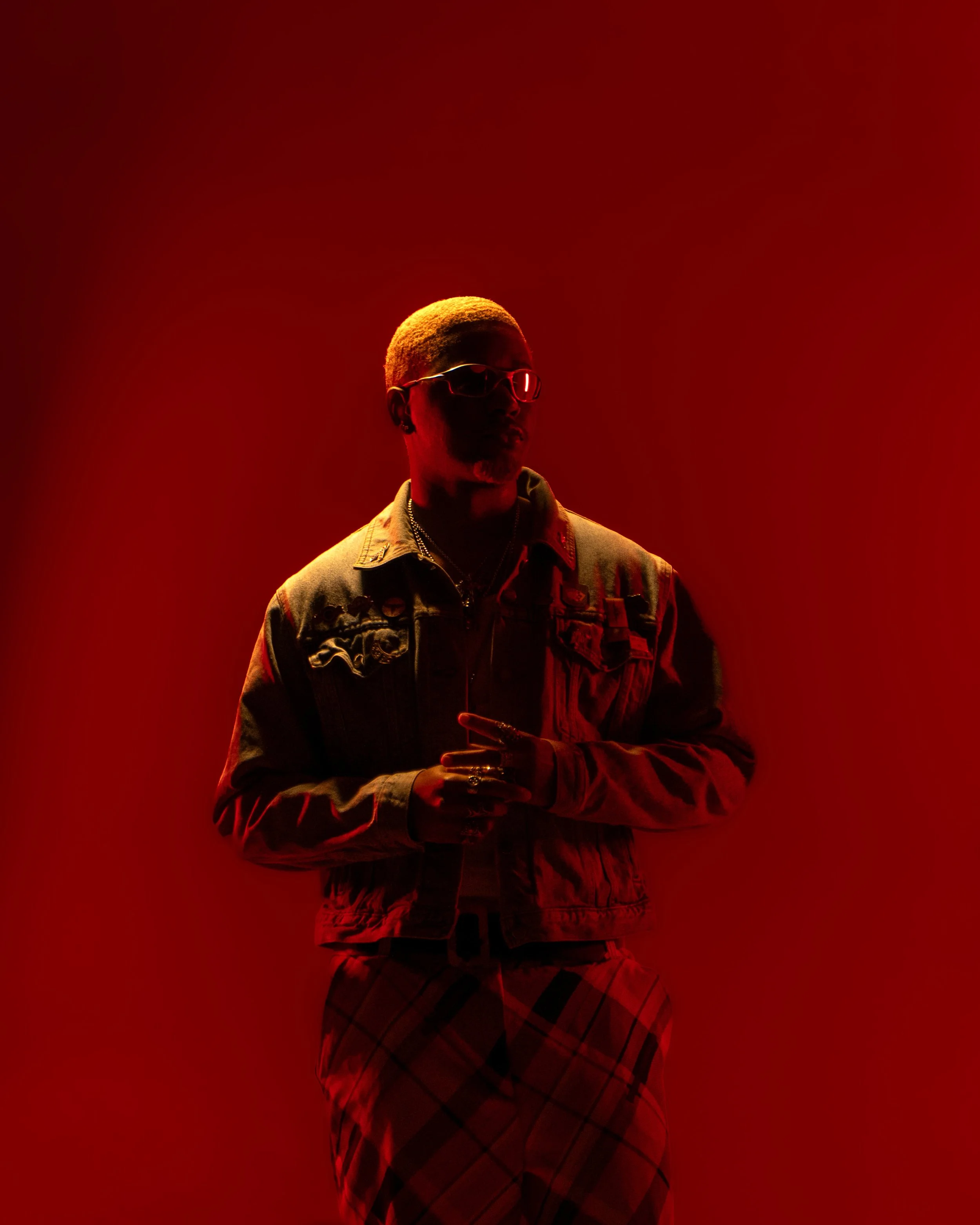 Portrait of a man with orange hair bathed in red while face is covered in shadow. Portrait taken in Austin Texas by an Austin Texas Photographer.
