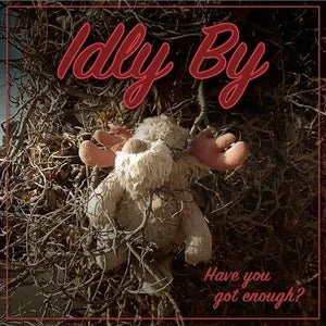 A stuffed teddy bear tangled in tree branches with the text 'Ildy By' and 'Have you got enough?' overlaid.