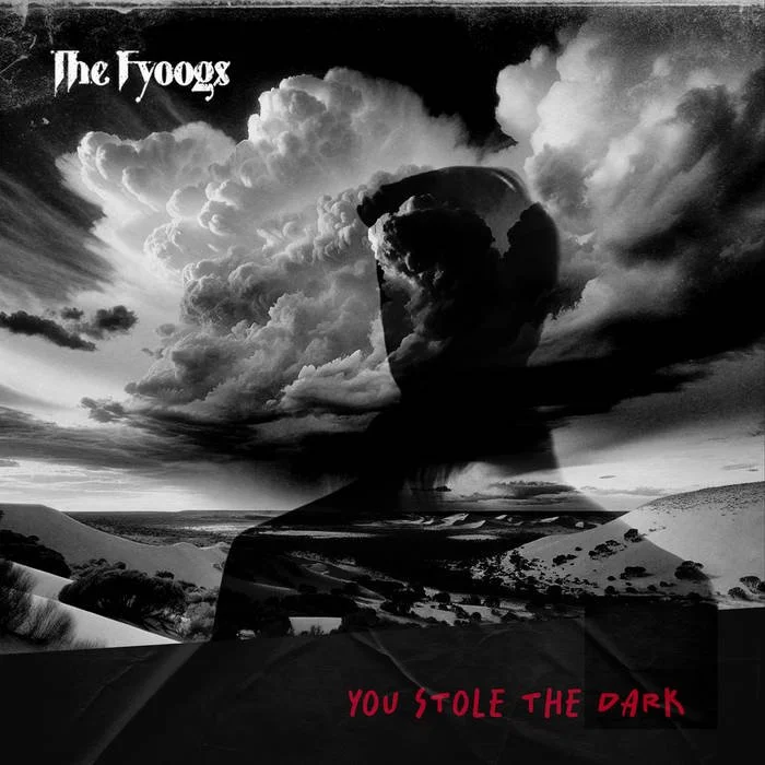 Black and white album cover for The Foogs titled "You Stole the Dark," featuring a landscape with clouds and a person’s profile silhouette blending into the sky.