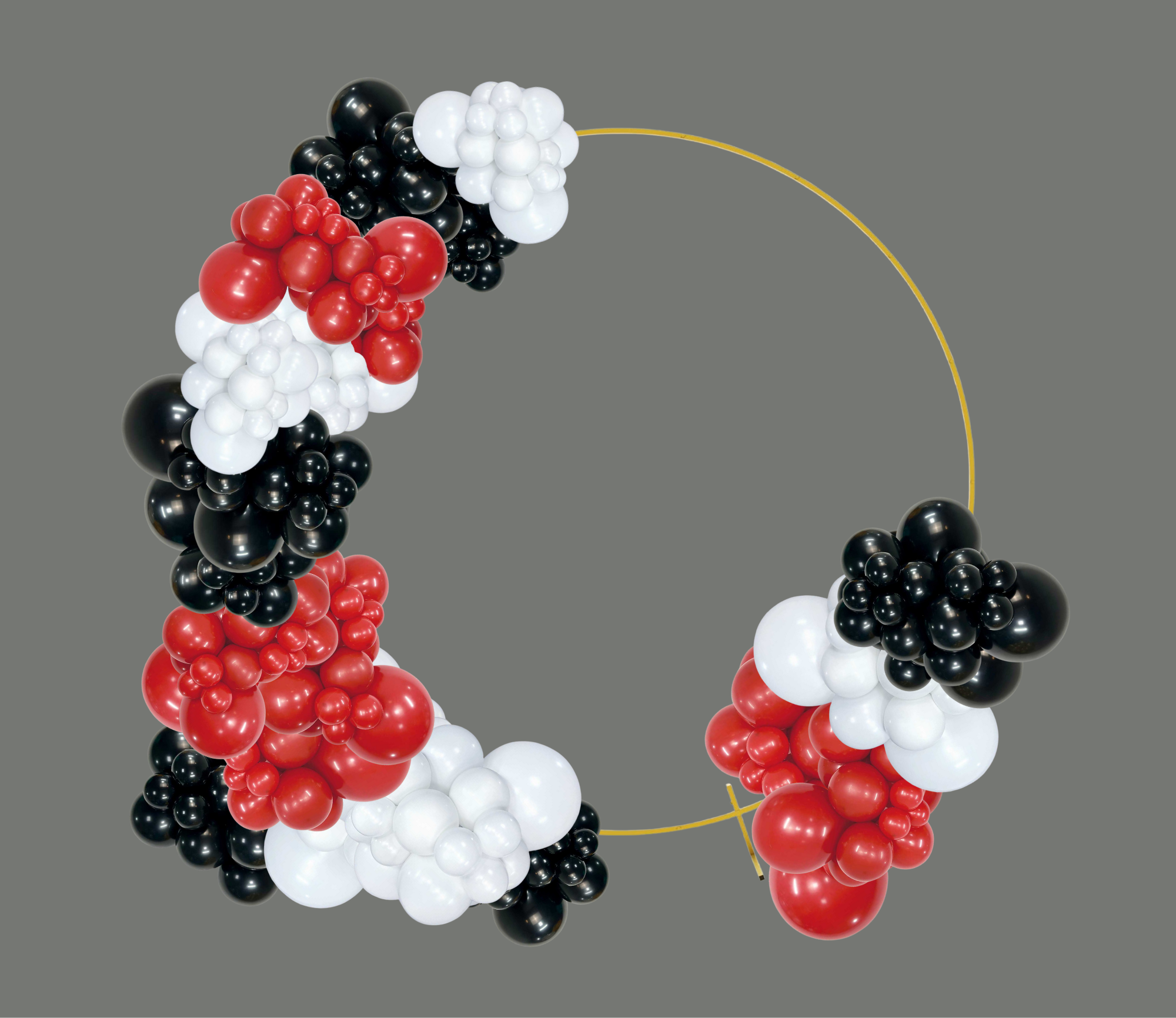 Circular arrangement of organic balloons in black, white, and red colors on a gray background.