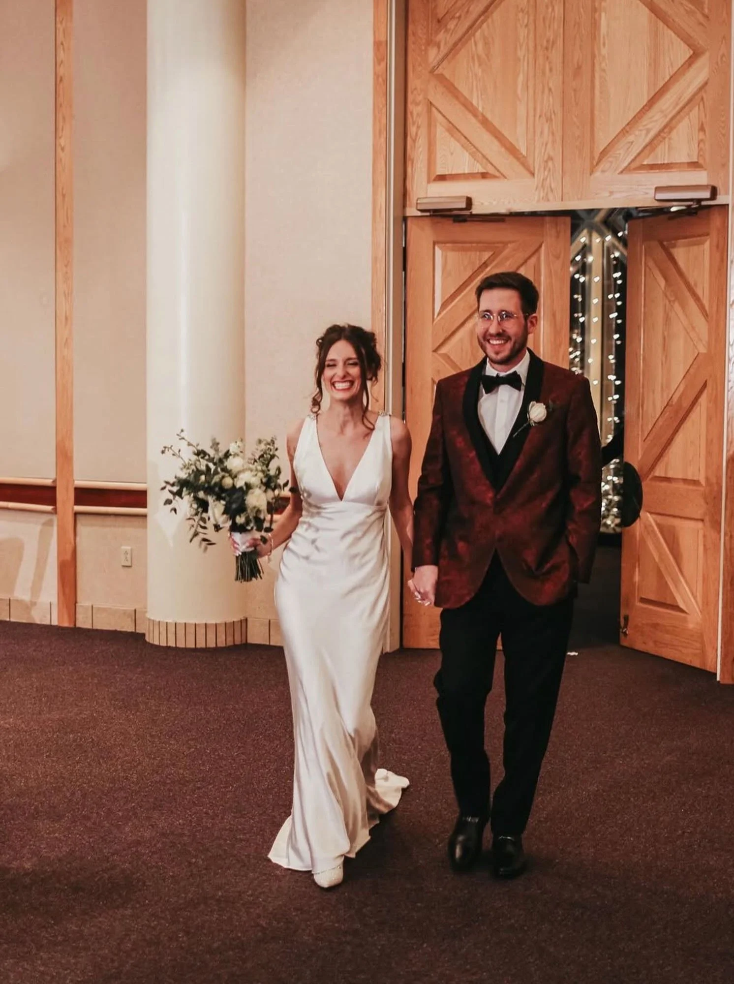 Bride holding white and green bouquet at reception, clients of Outer Banks floral preservation by Beaux’s Botanicals