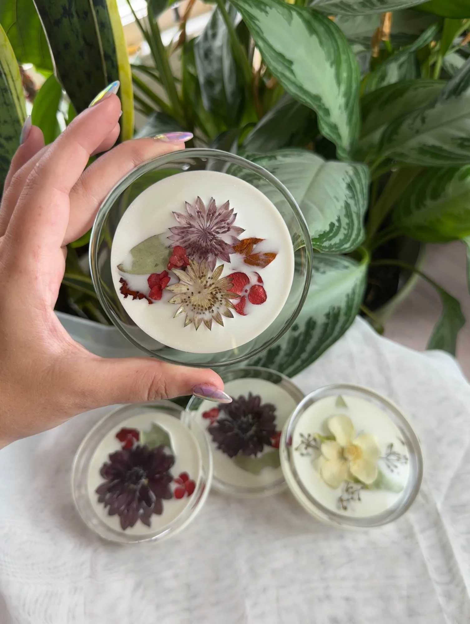 Close-up of a resin highball coaster with preserved wedding flowers, made by Beaux’s Botanical Preservation in the Outer Banks