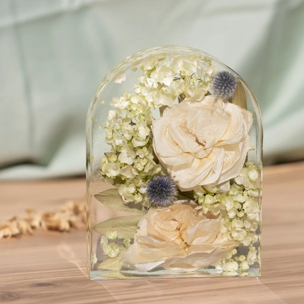 Arch-shaped resin block preserving hydrangeas and thistle from a wedding bouquet, created by Beaux’s Botanical Preservation in Outer Banks NC