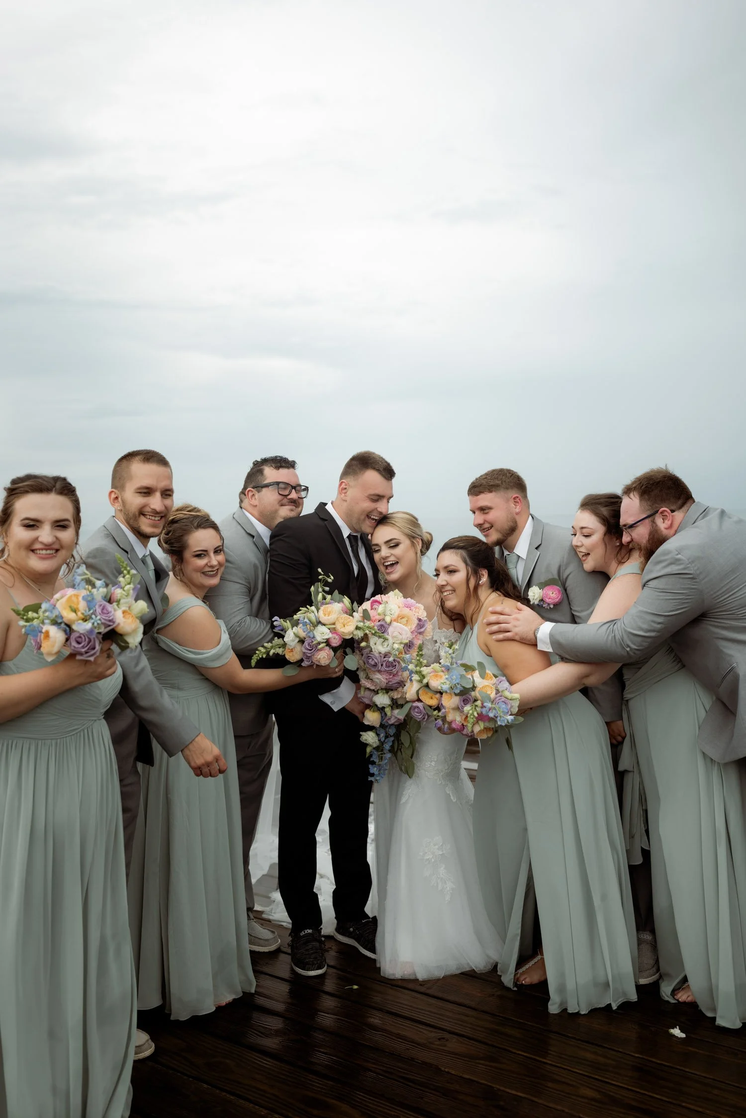 Wedding party carrying soft pastel bouquets later preserved by Beaux’s Botanical Preservation in Outer Banks NC
