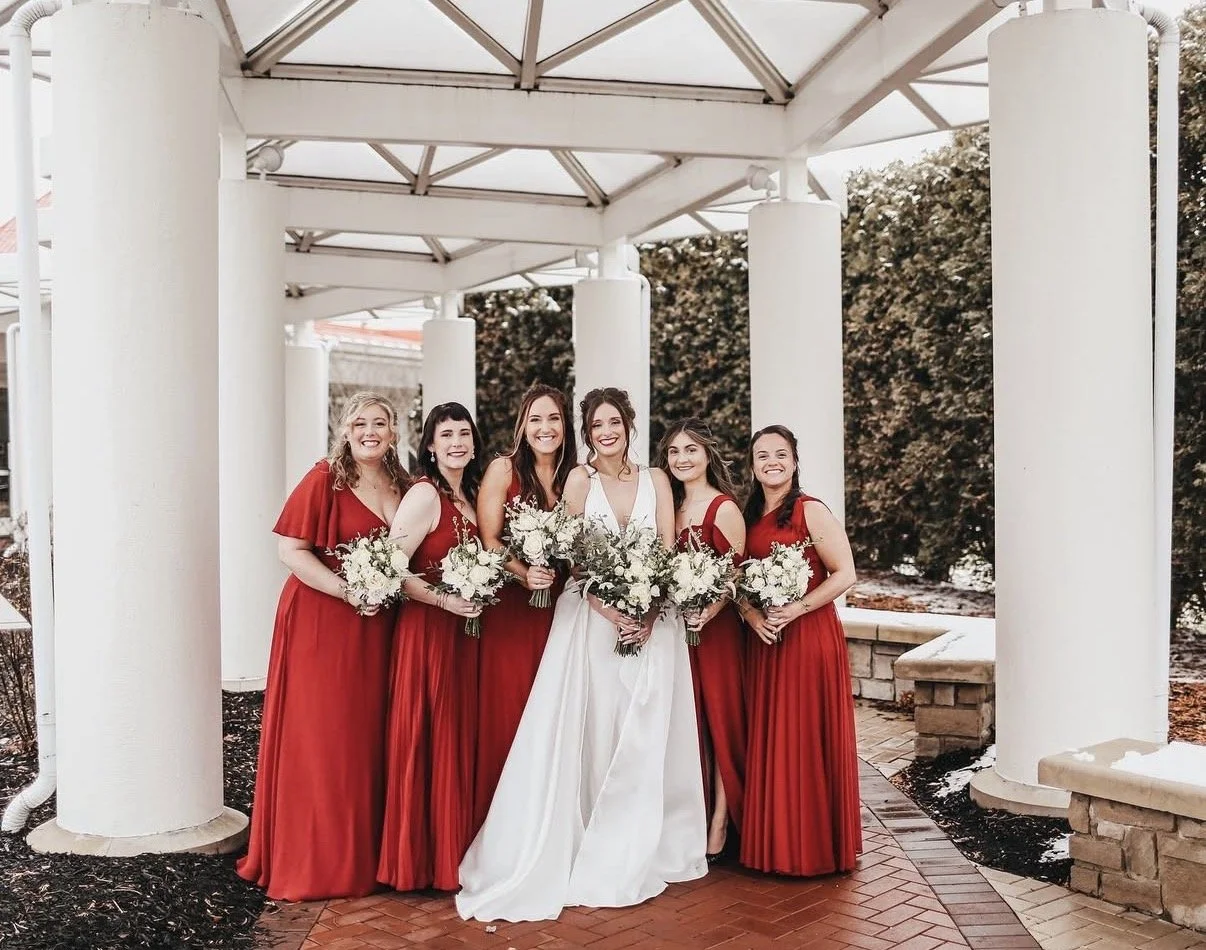 Bridal party holding white wedding flowers from an Outer Banks celebration preserved by Beaux’s Botanical Preservation