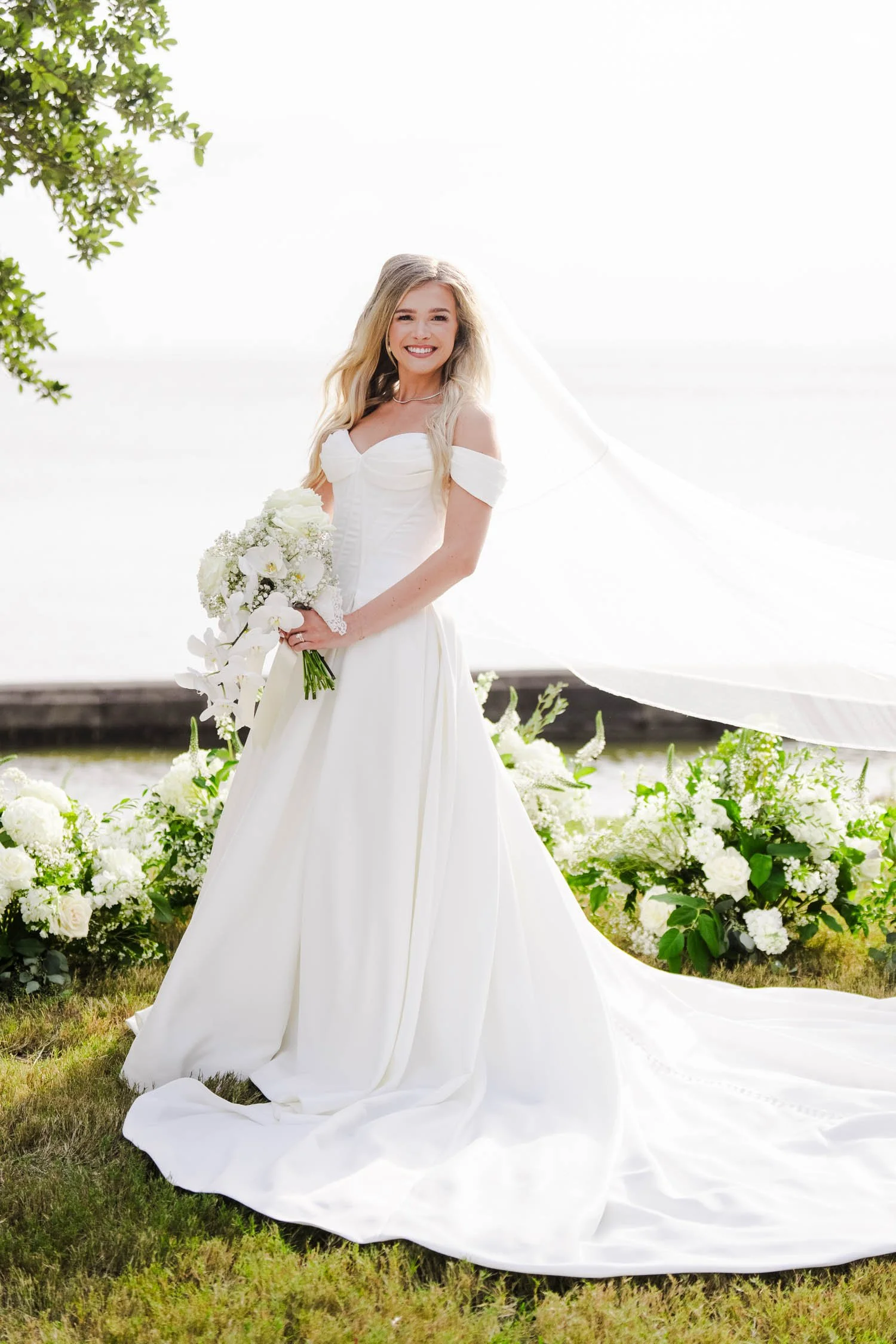 Bride holding a classic all-white wedding bouquet before floral preservation by Beaux’s Botanical Preservation in Outer Banks NC