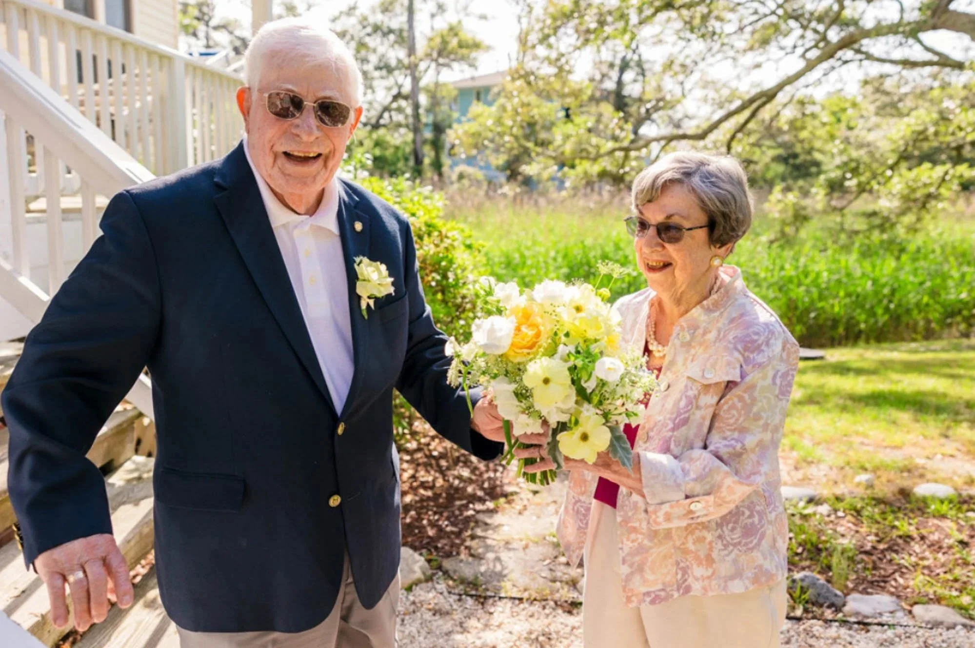 Vow renewal couple holding yellow and white bouquet for preservation, by Beaux’s Botanical Preservation