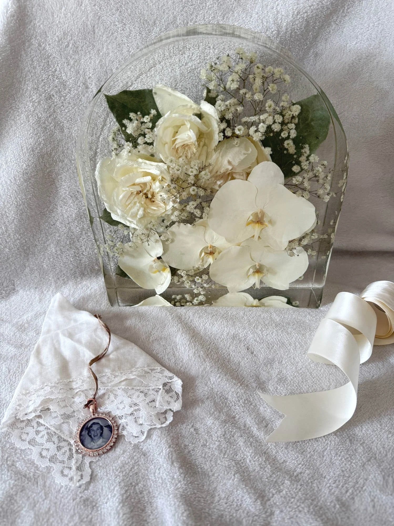 Arch resin block preserving white bouquet with dogwood, handkerchief and locket, by Beaux’s Botanicals OBX