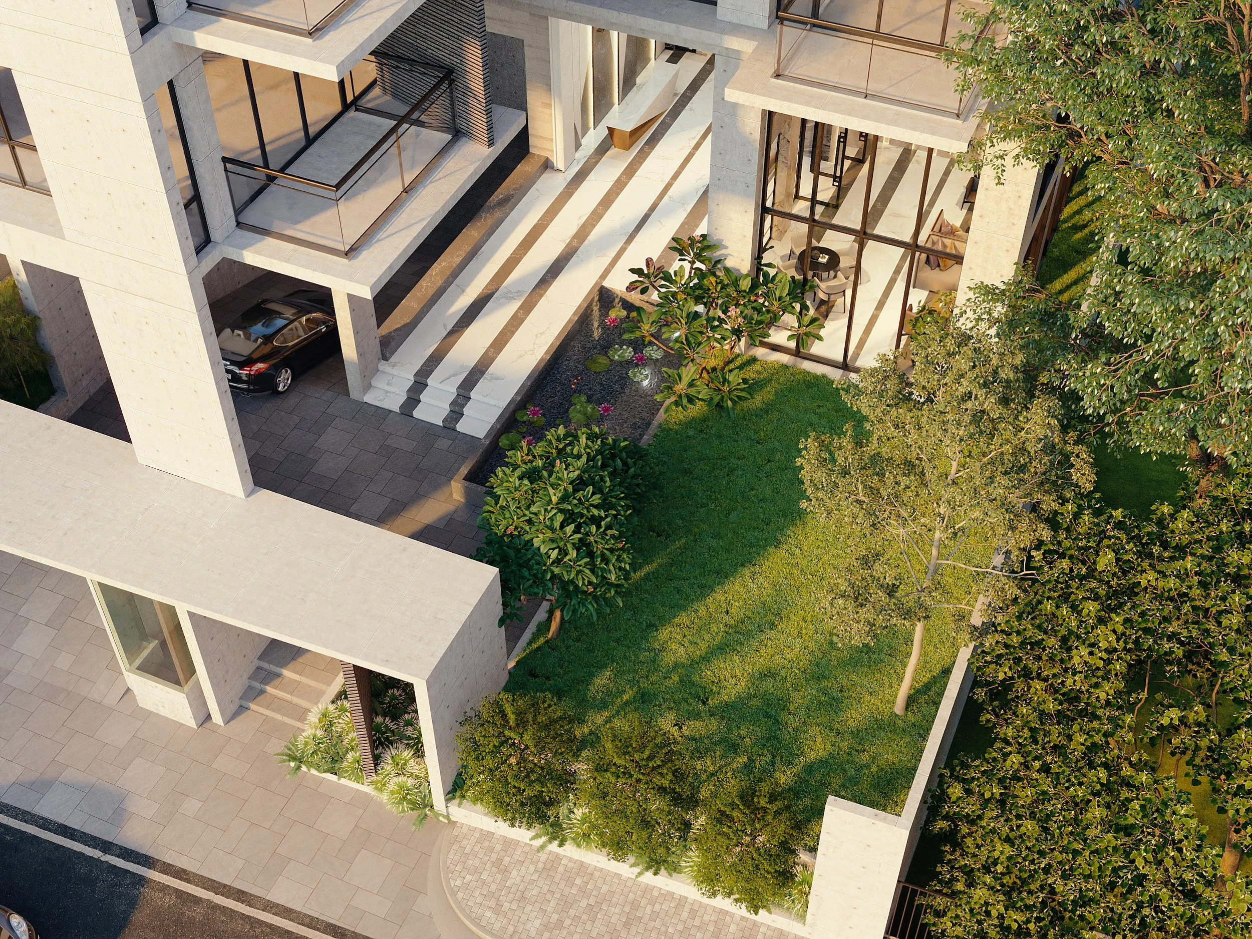 An aerial view of a modern residential building with a driveway, garage, outdoor steps, trees, and a grassy yard with flowering plants.