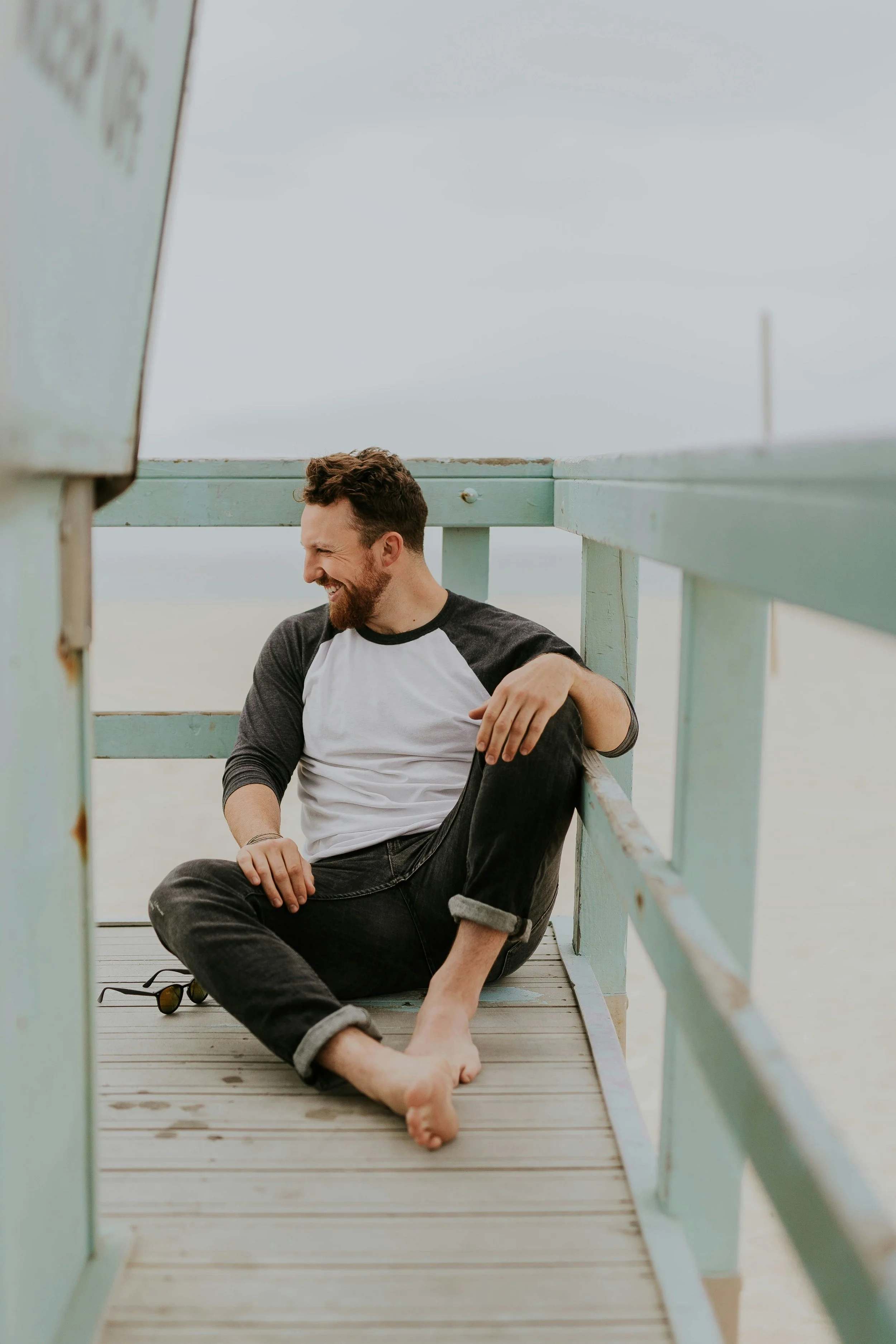 healthy man sitting on pier at beach