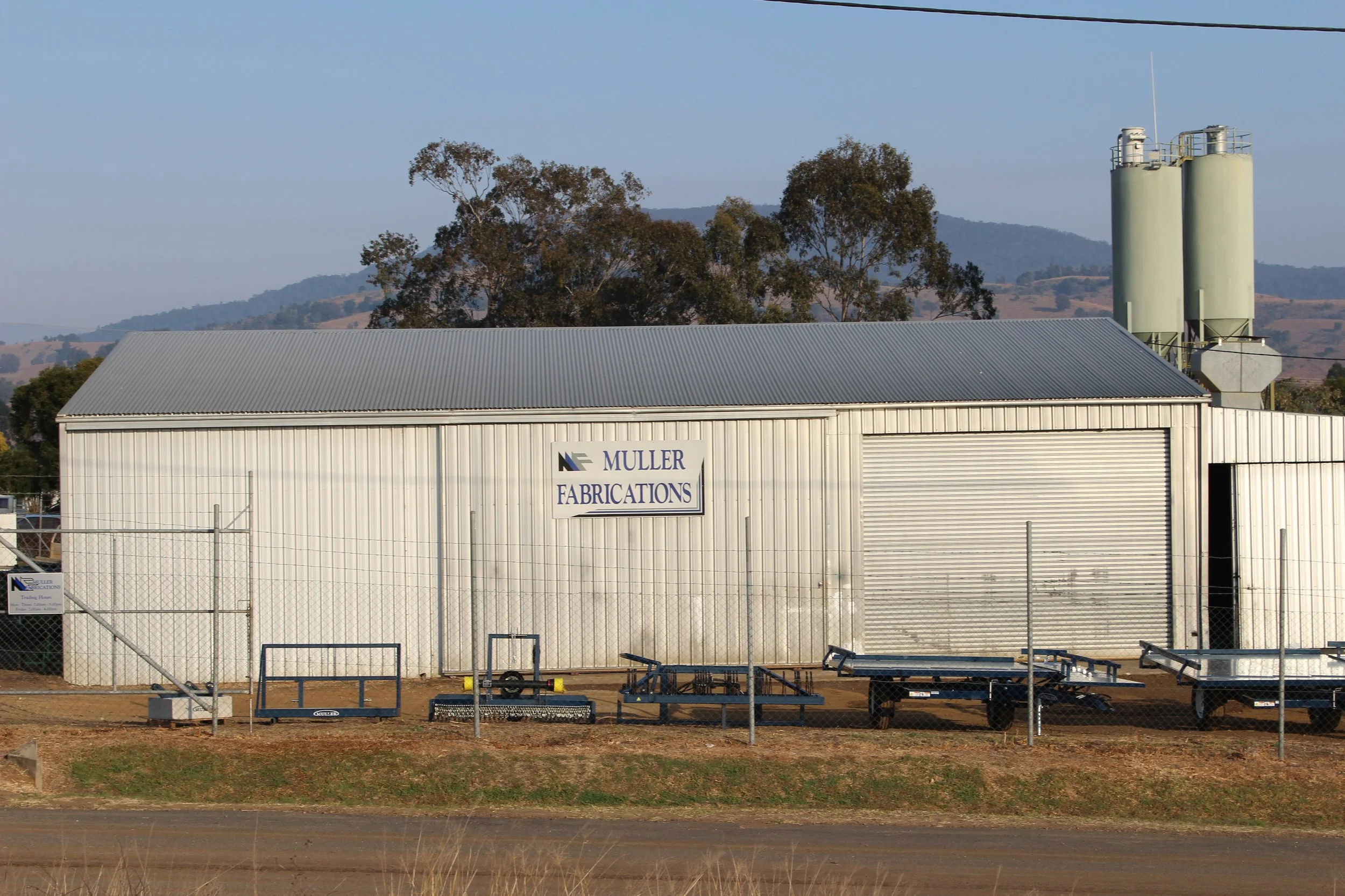 Muller Fabrications workshop in Boonah, Queensland, with locally manufactured agricultural equipment displayed outside.