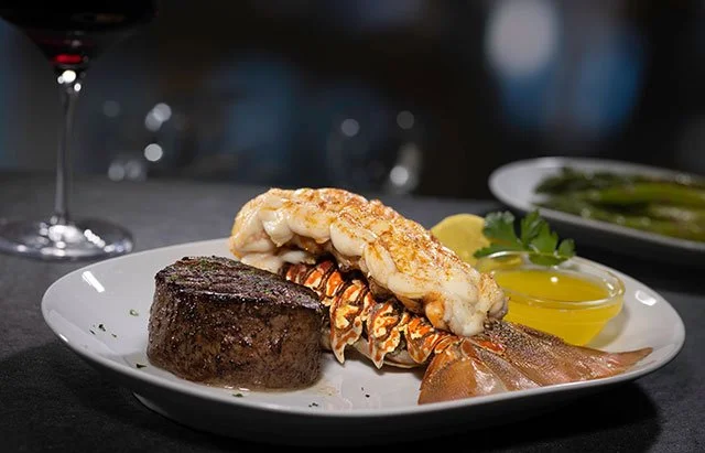 Surf and turf with steak, lobster, and butter at Eddie V's Prime Seafood in Plano, Texas.