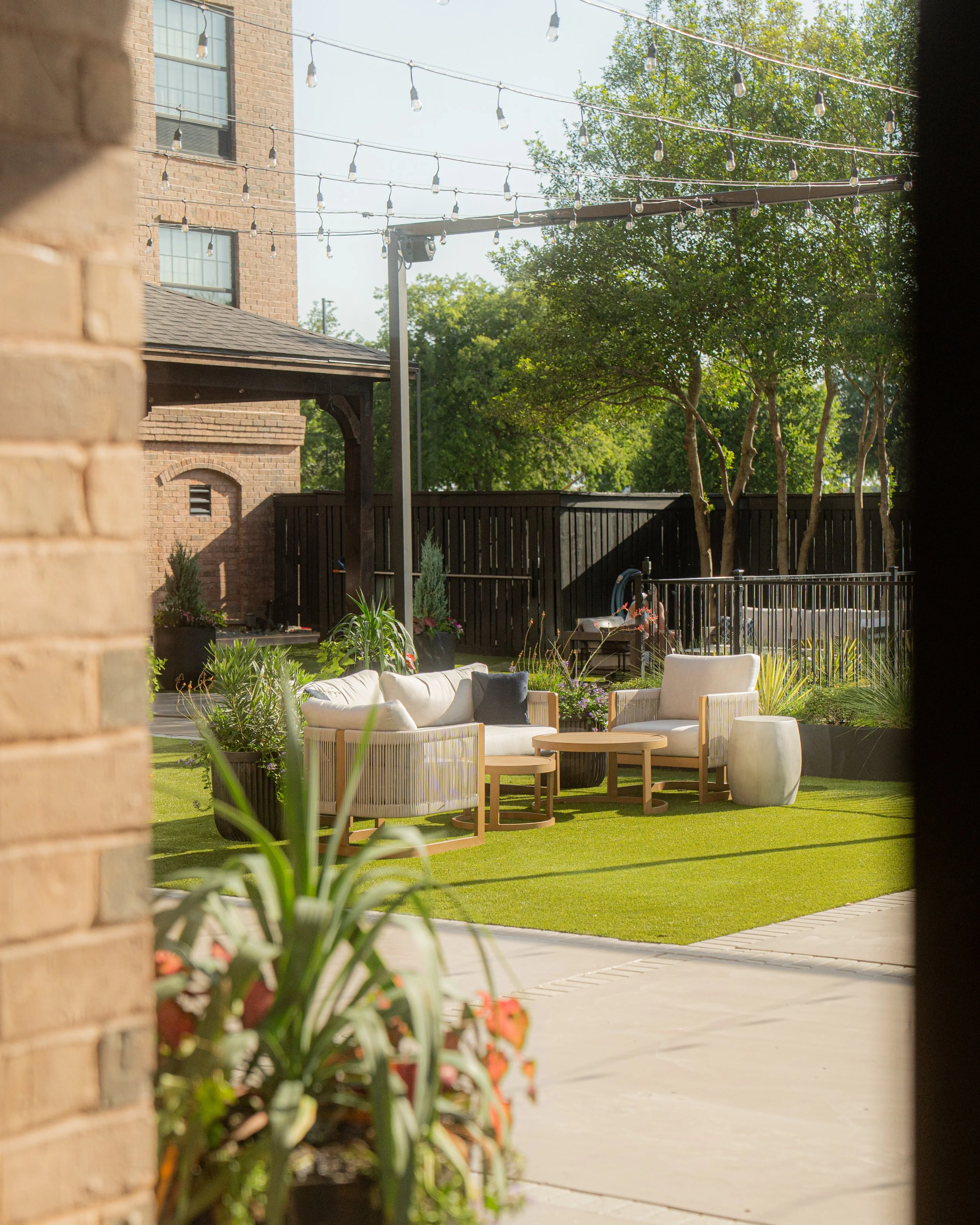 Outdoor lounge seating in the courtyard at The Clara Hotel in Plano, Texas.