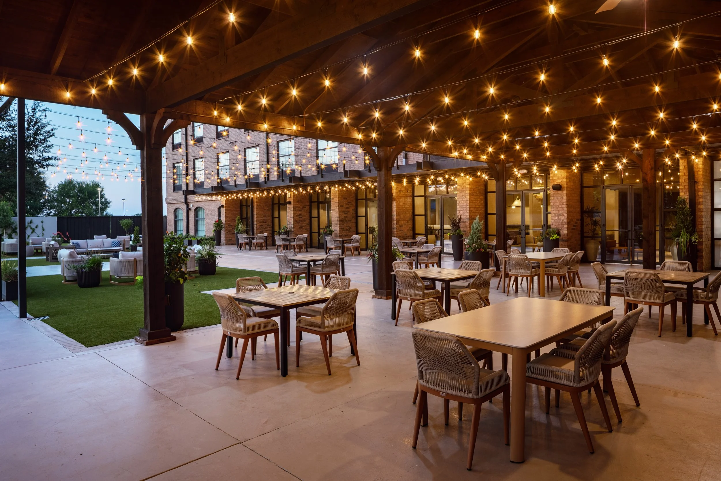 Outdoor gazebo event space with string lights and seating at The Clara Hotel in Plano, Texas.