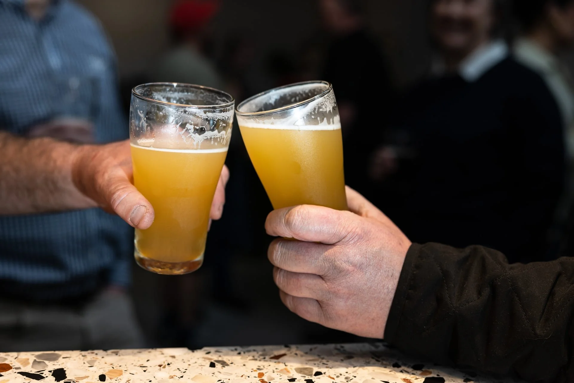 Friends clinking craft beers at Old Mill Brewery in Tanunda, Barossa Valley.