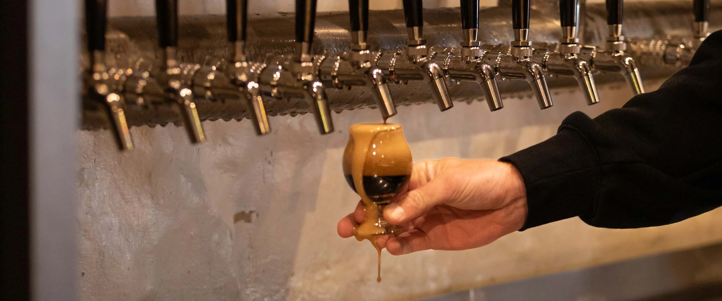 Fresh beer being poured from tap at Old Mill Brewery in Tanunda, Barossa Valley, showcasing craft beer on tap in a local brewery setting.