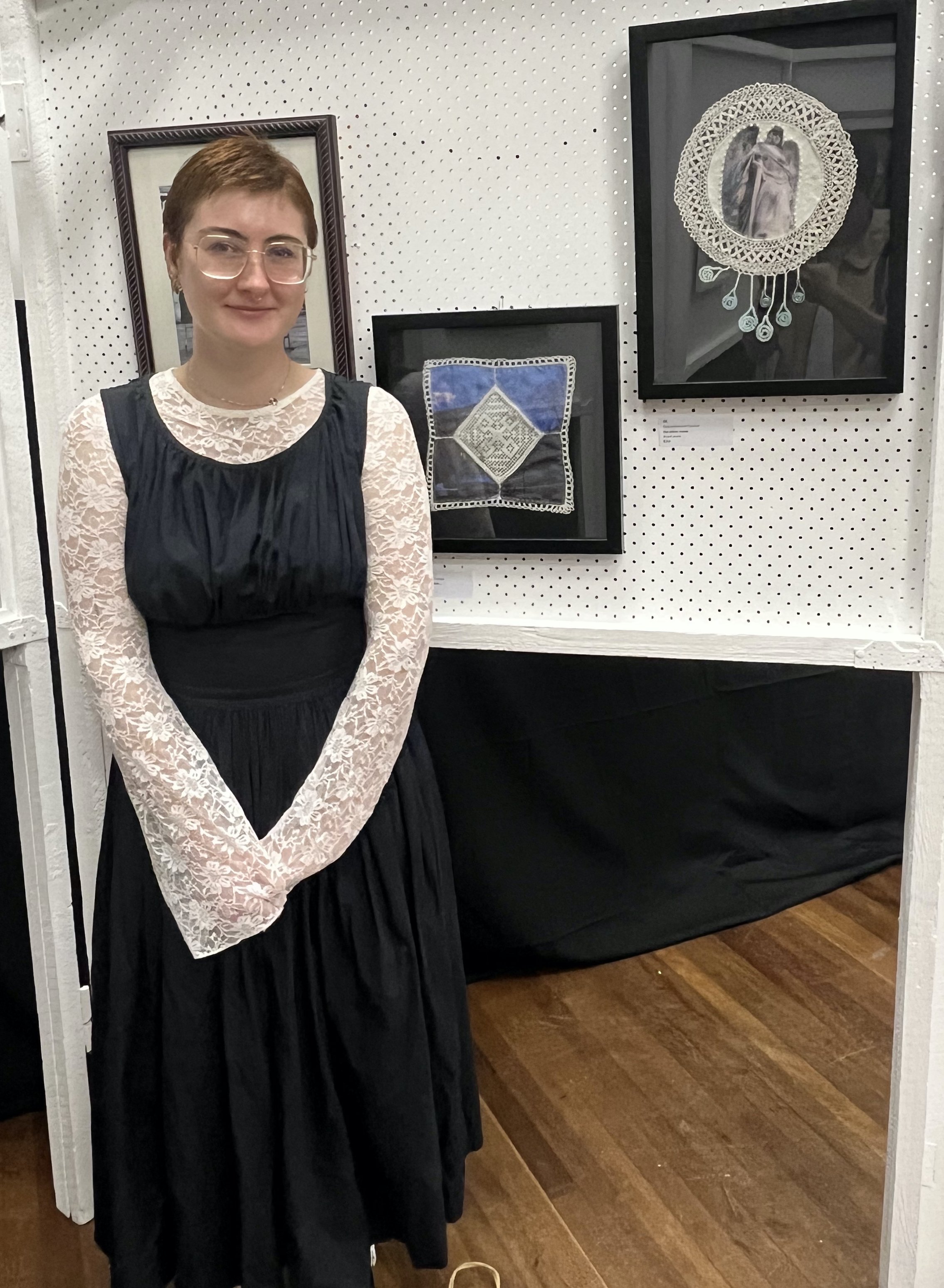 Samantha Lee Curran standing in front of two of her textile artworks at Blue Mountains Artfest 2025