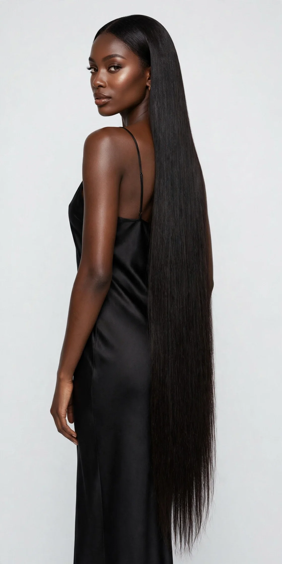 Model with very long, sleek straight hair extensions against a clean studio background