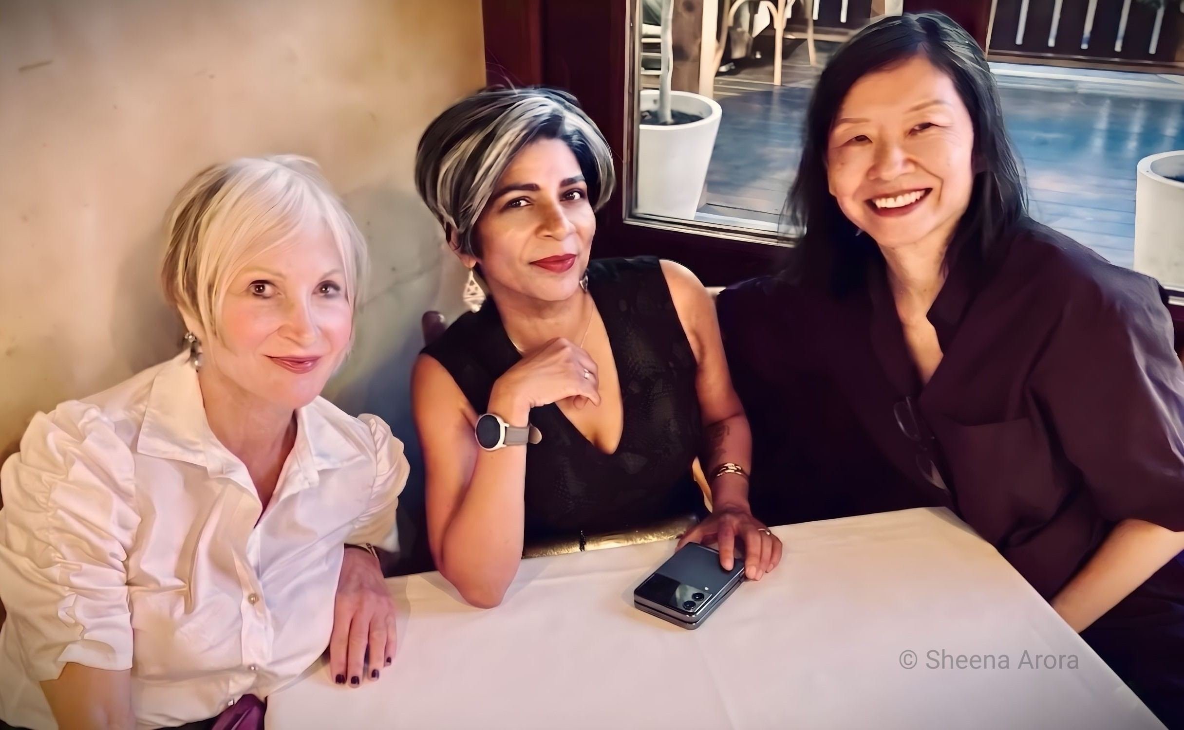 Author Sheena Arora (center) and fellow members of the Writers with the Right Words (WRW) critique group sharing a meal and conversation, representing the camaraderie and trust built within the literary fiction workshop.