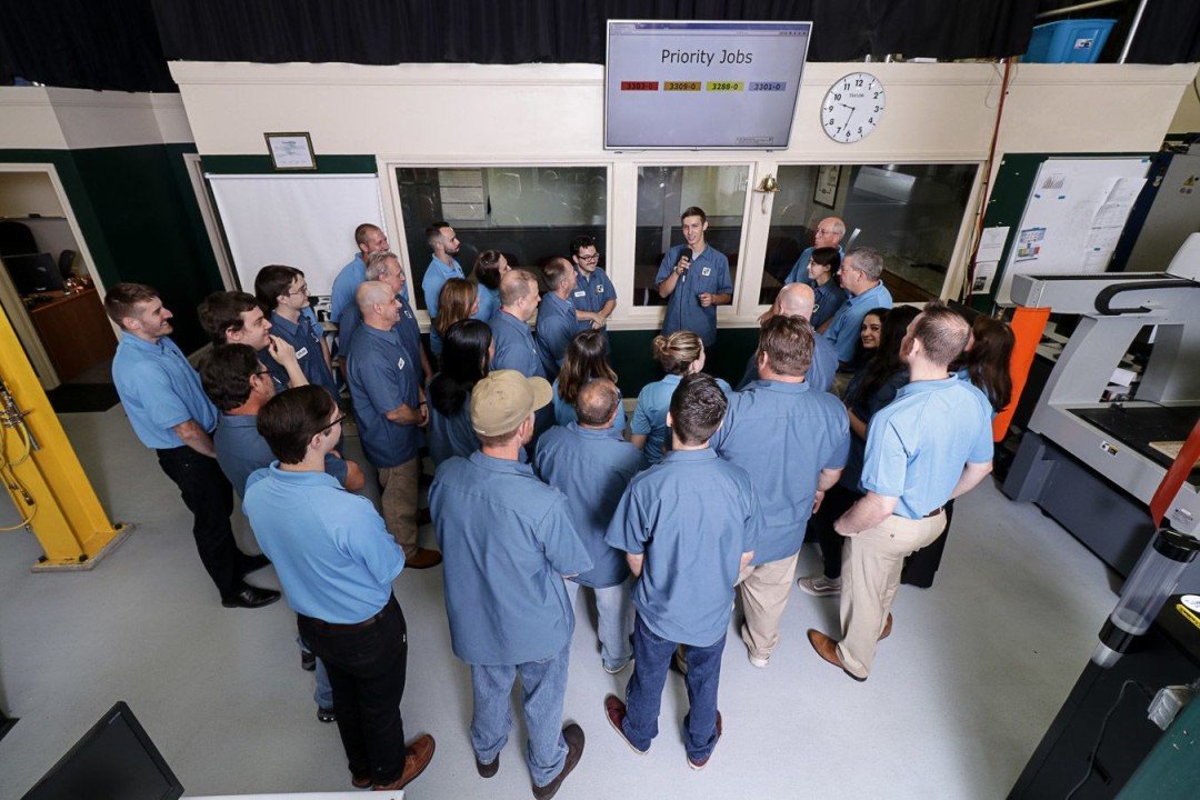 Close-up of a multicolored brick wall with various shades of red, brown, gray, and black bricks.