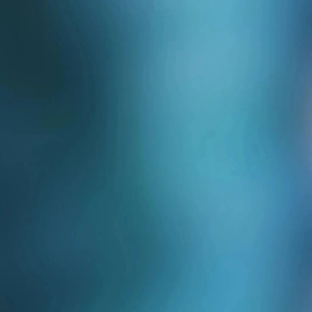 Blurry blue and teal abstract background with gradient.