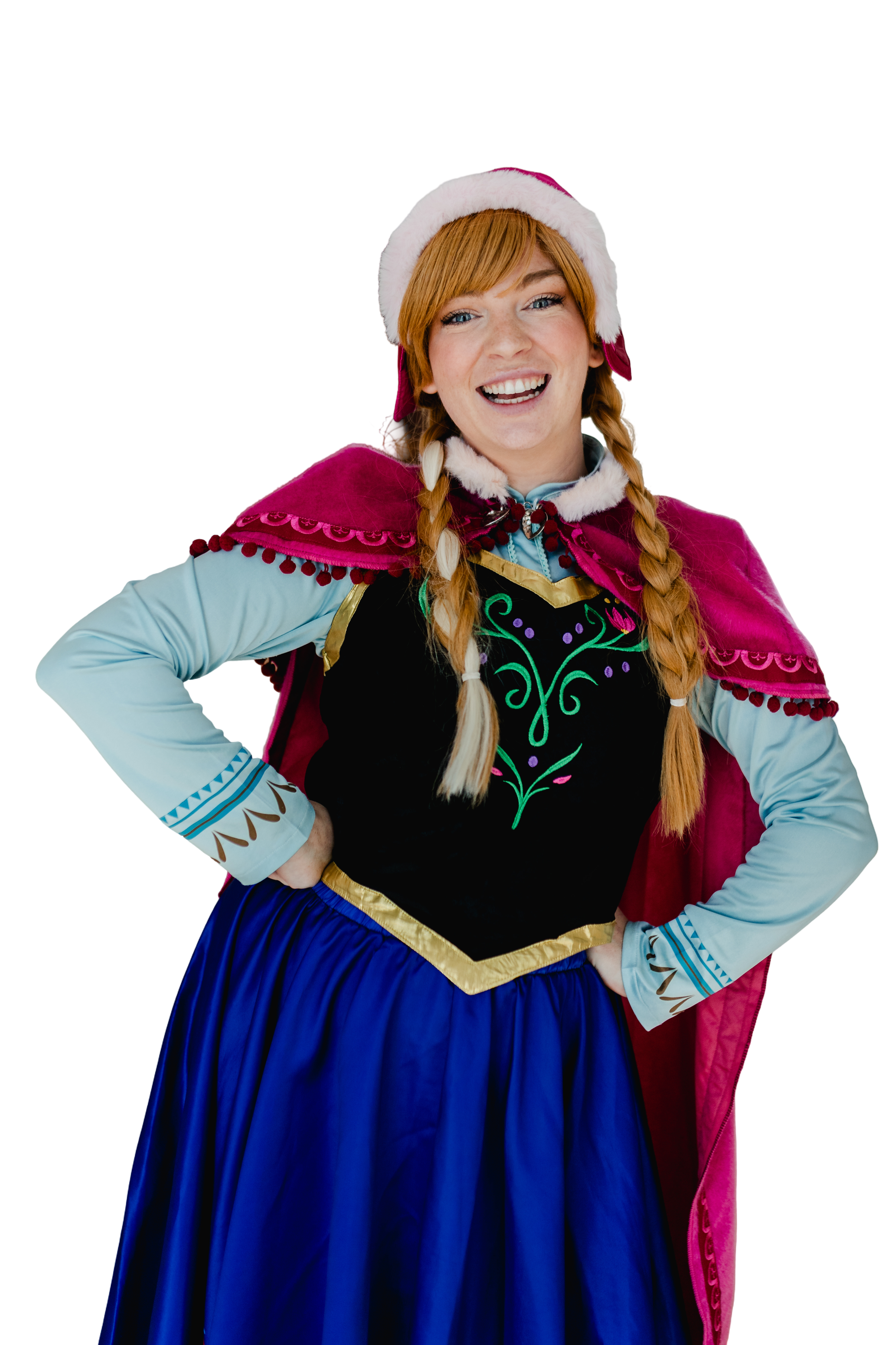 Woman dressed as Anna from Frozen, wearing a Santa hat and a festive cape, smiling with hands on hips.