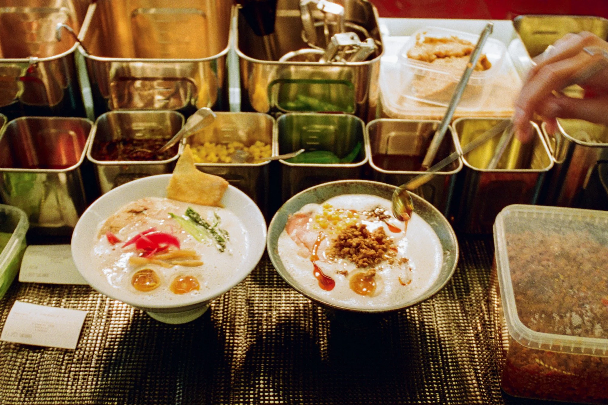 Preparing tare and toppings for ramen at RIKI RAMEN BĀ