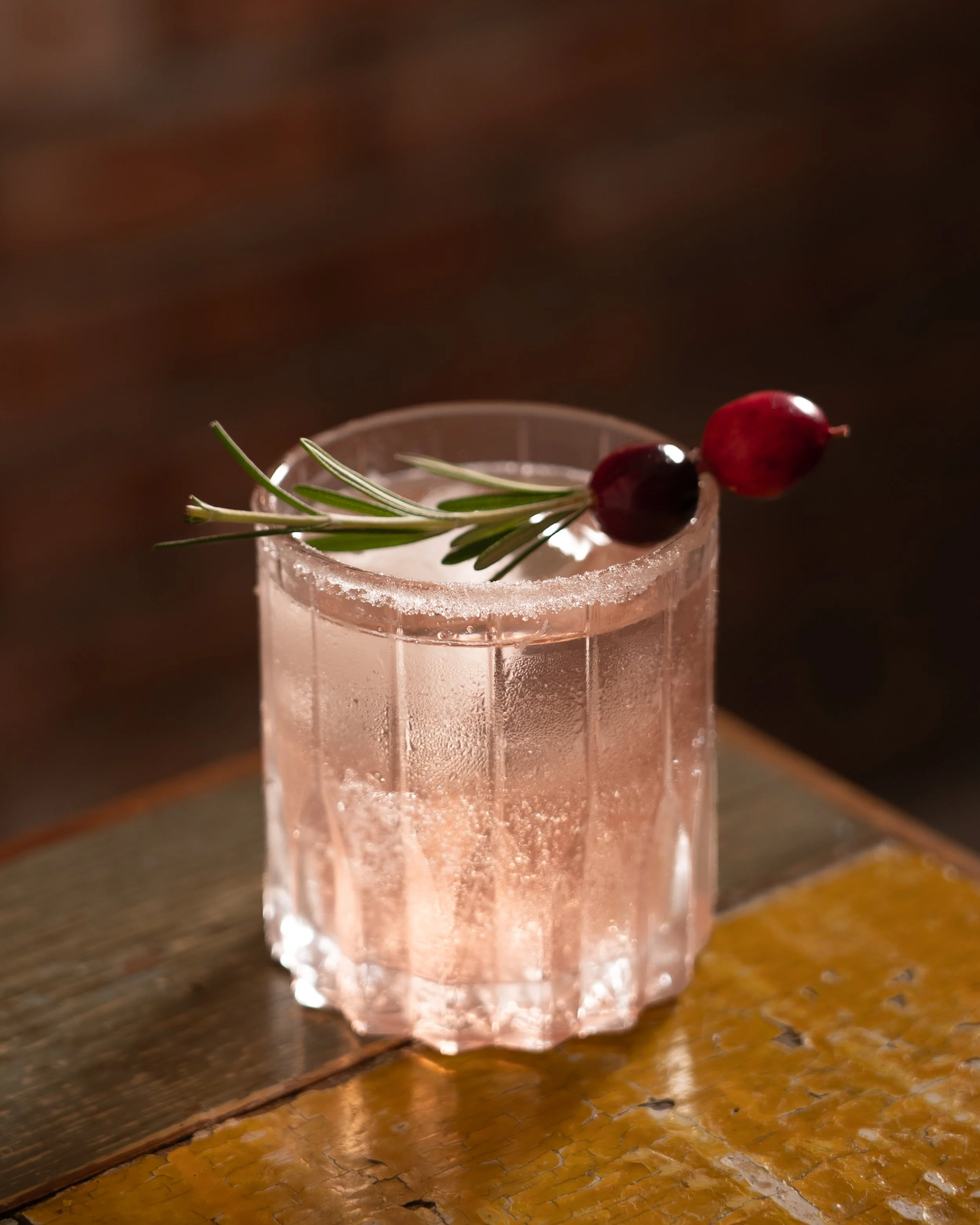 Elegant pink cocktail with rosemary garnish shot by a photographer in kl