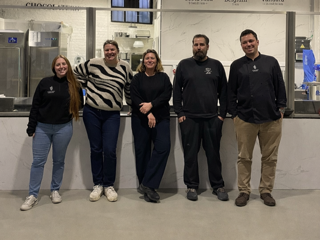 Team Fermentastic. Five people posing together in a restaurant or cafe kitchen, smiling at the camera.