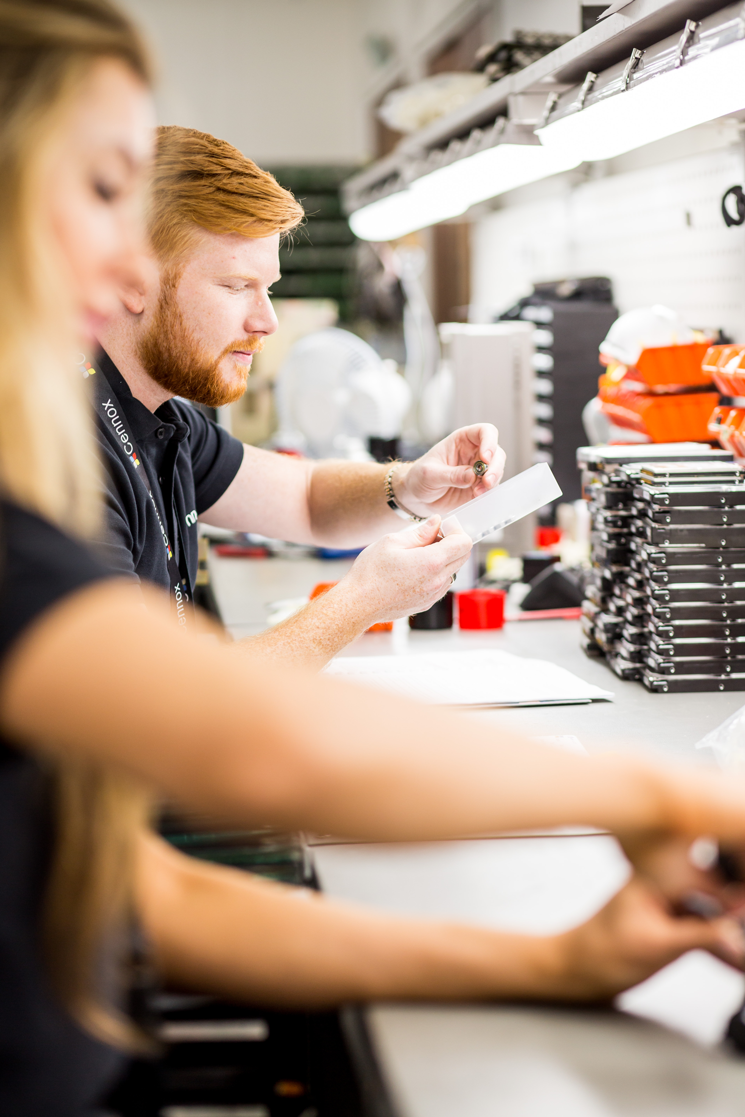 Cennox staff working at a parts repair and refurbish desk