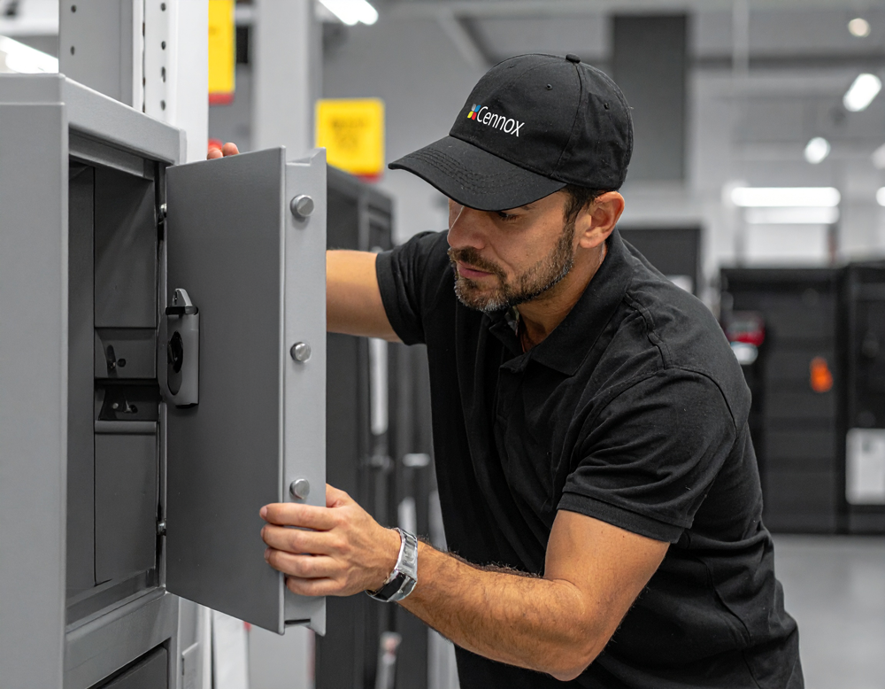 A Cennox engineer installing a safe