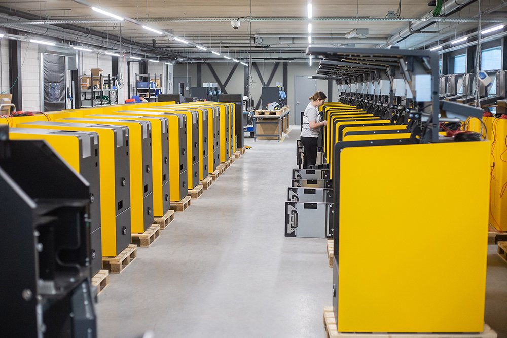 A worker building smart safes, cash recyclers and payment terminals in our factory