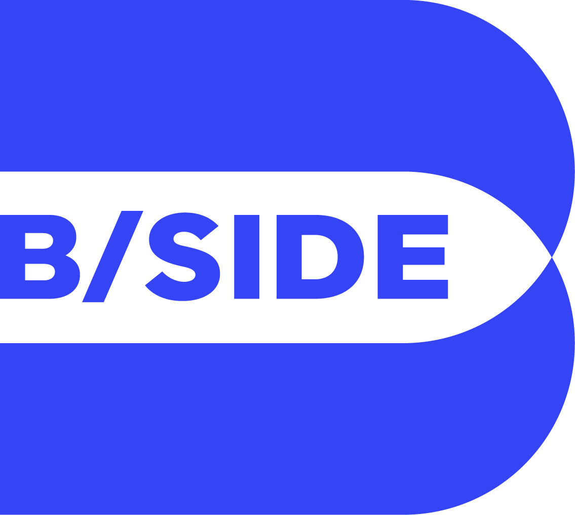 Blue and black logo with the word "B/SIDE" in bold, stylized text.