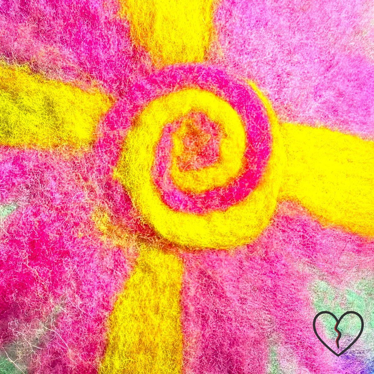 Hand dyed merino wool felted skullcap hat in purple, pink, and solar yellow with spiral sun symbol on crown